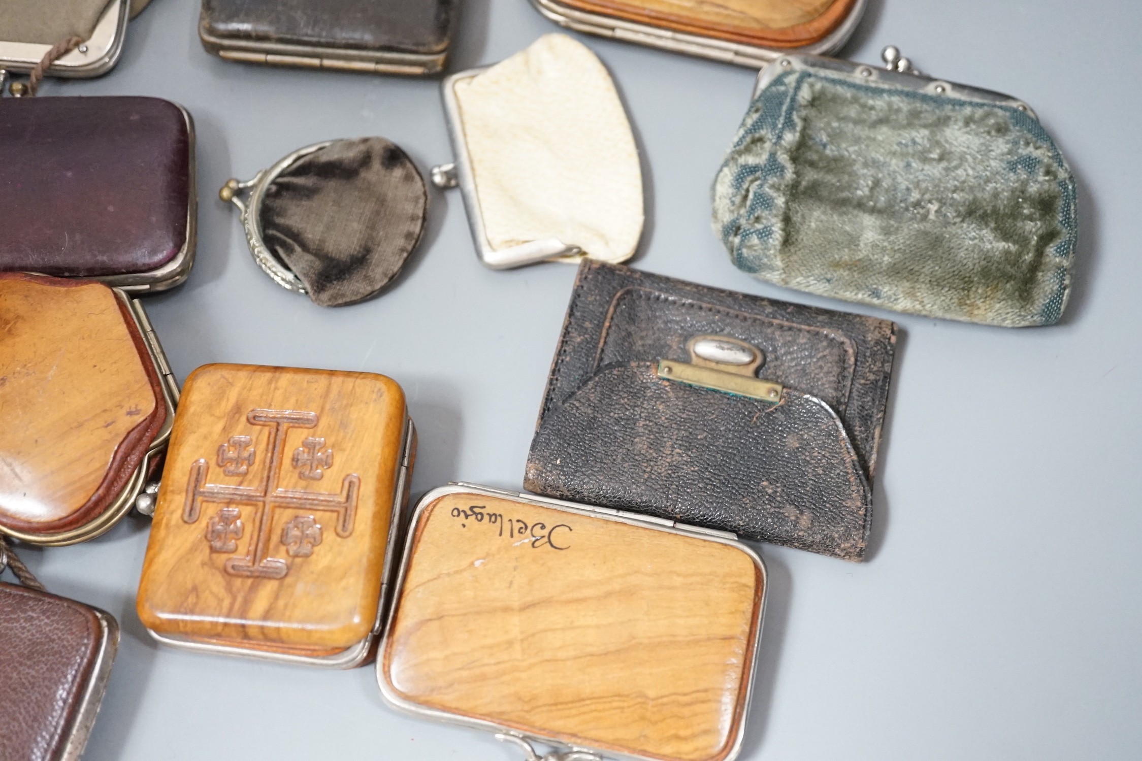 A collection of mostly Grand Tour, wooden souvenir purses and other 19th and 20th century leather and fur purses